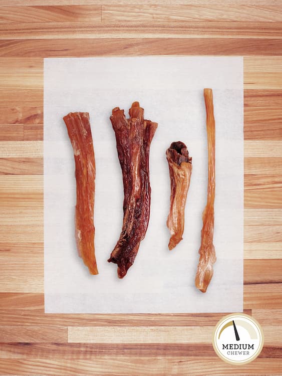 a variety of beef tendons on a butcher block countertop