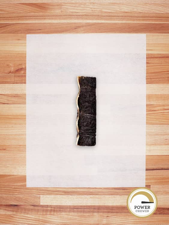 large beef hide roll with hair on a butcher block countertop