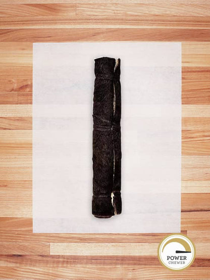 giant beef hide roll with hair on a butcher block countertop