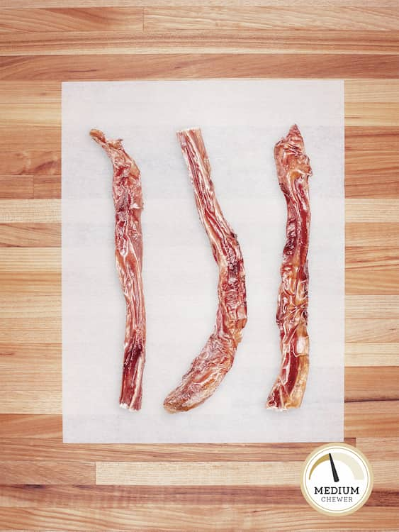 three thin bully sticks on butcher block countertop