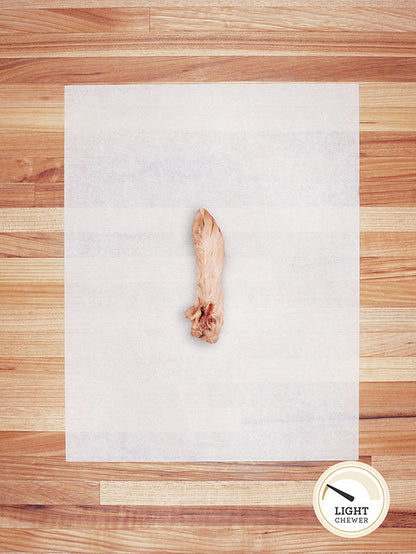 large white rabbit foot on a butcher block countertop