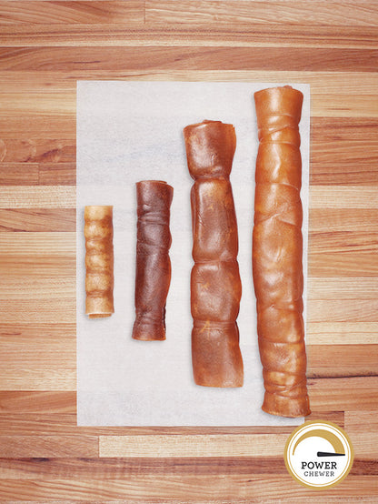 four rawhide rolls on a butcher block countertop